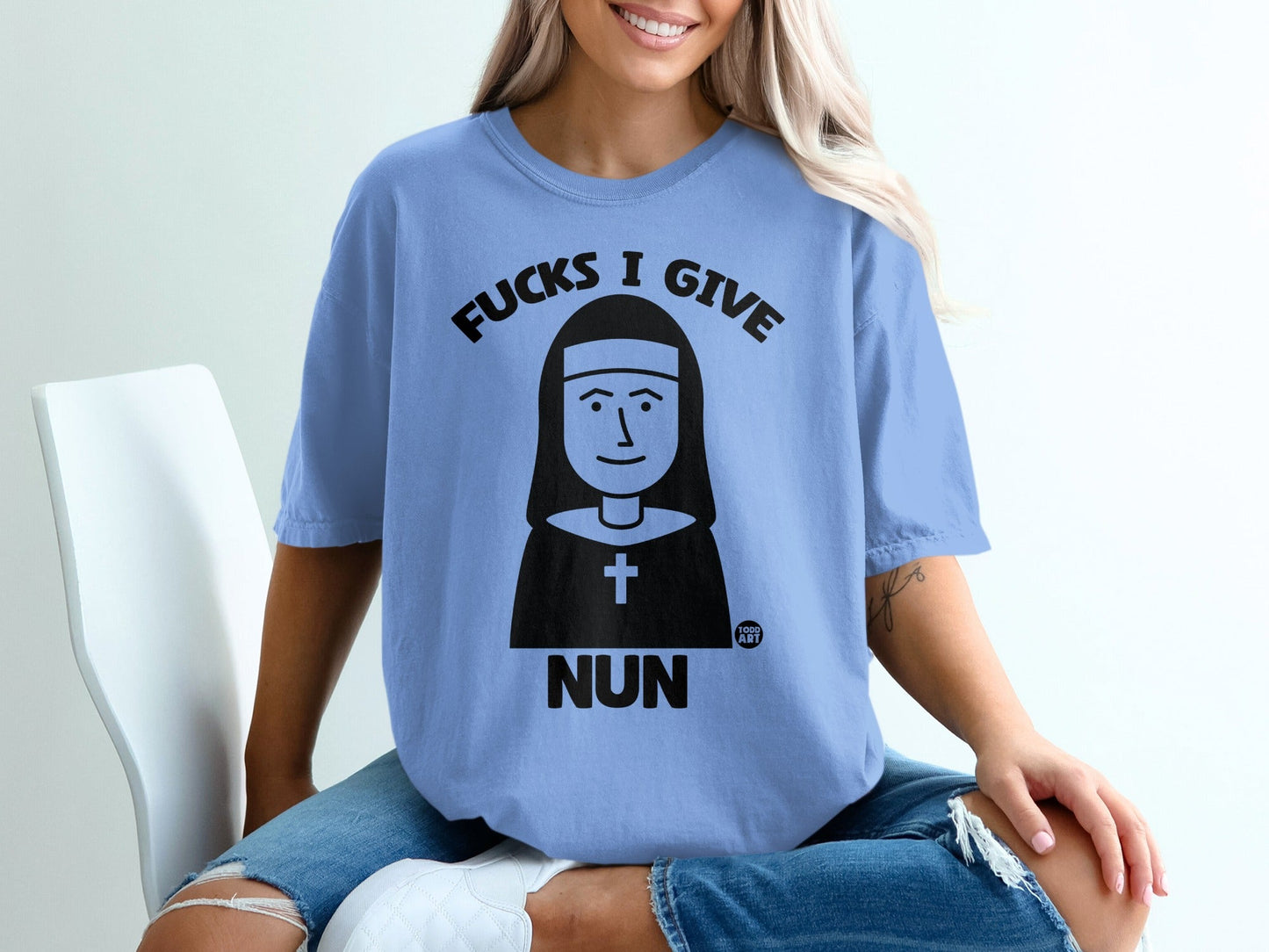 Light blue t-shirt with nun graphic and "Fucks I Give Nun" text.