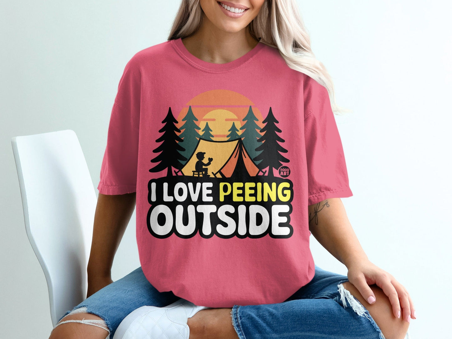 Pink t-shirt with "I Love Peeing Outside" graphic and camping scene.
