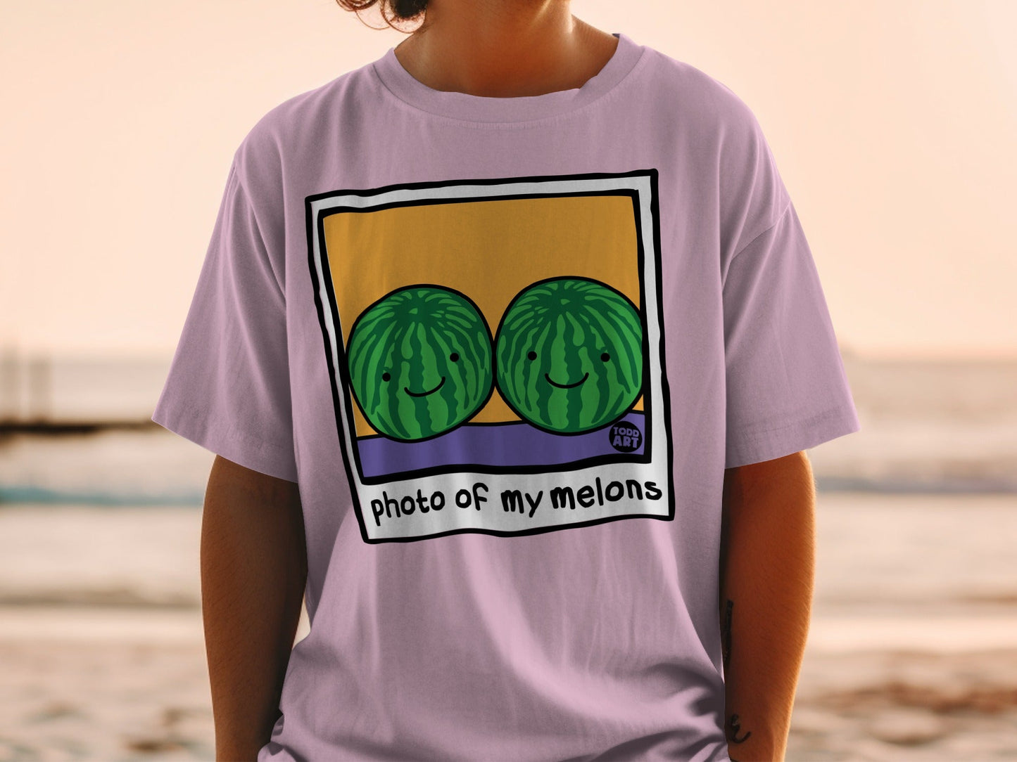 T-shirt with two smiling cartoon watermelons in a polaroid frame.