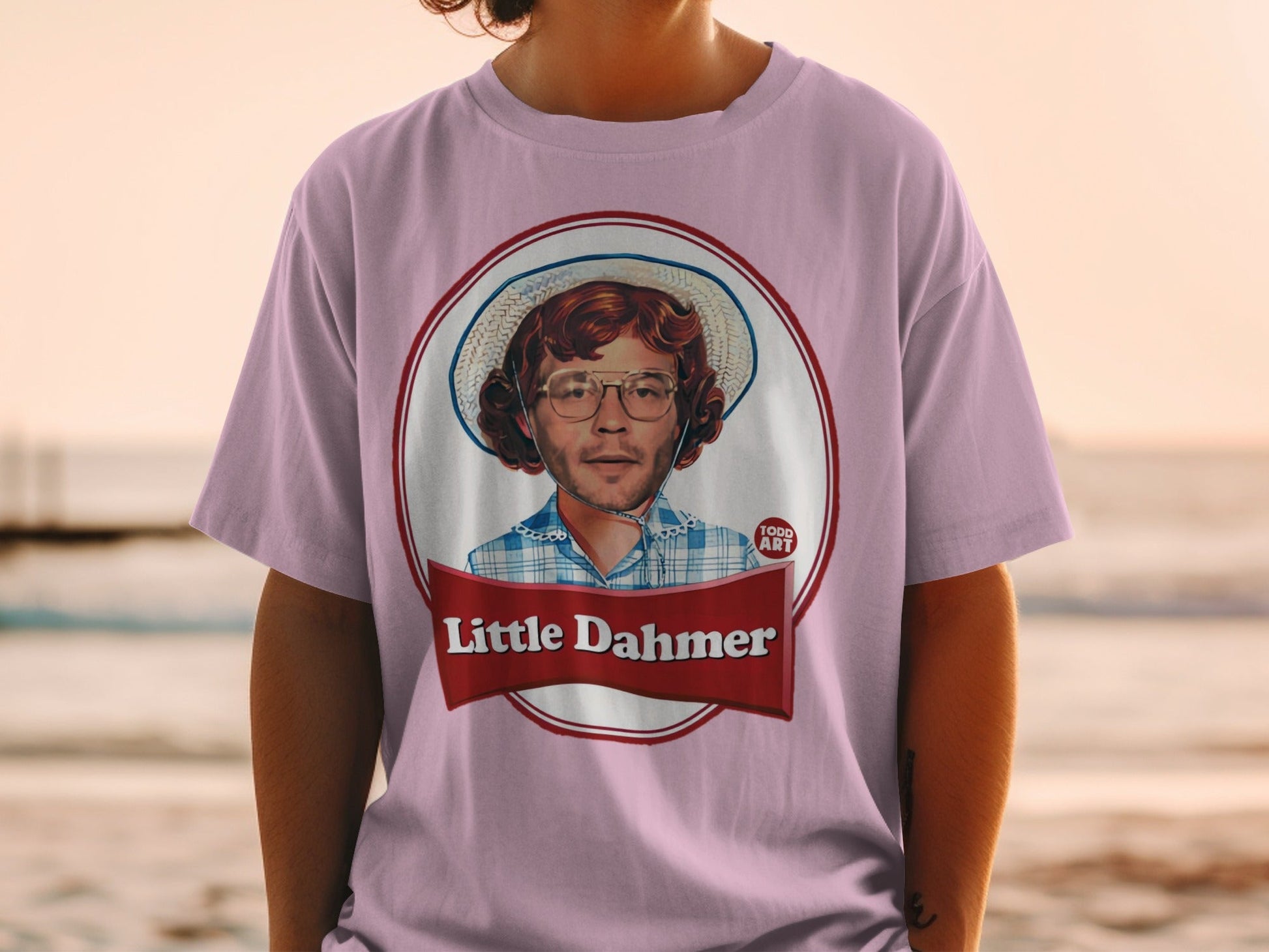 Purple t-shirt with "Little Dahmer" text and a circular portrait.