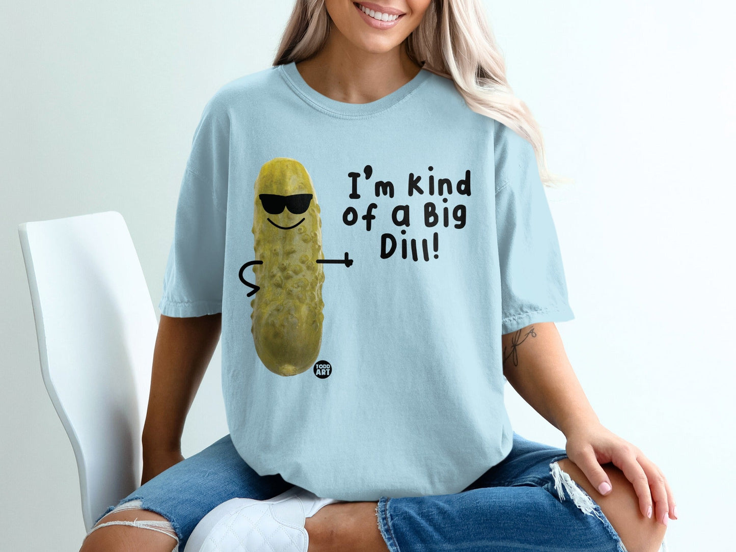 Light blue t-shirt with cartoon pickle wearing sunglasses saying "I'm kind of a Big Dill!".