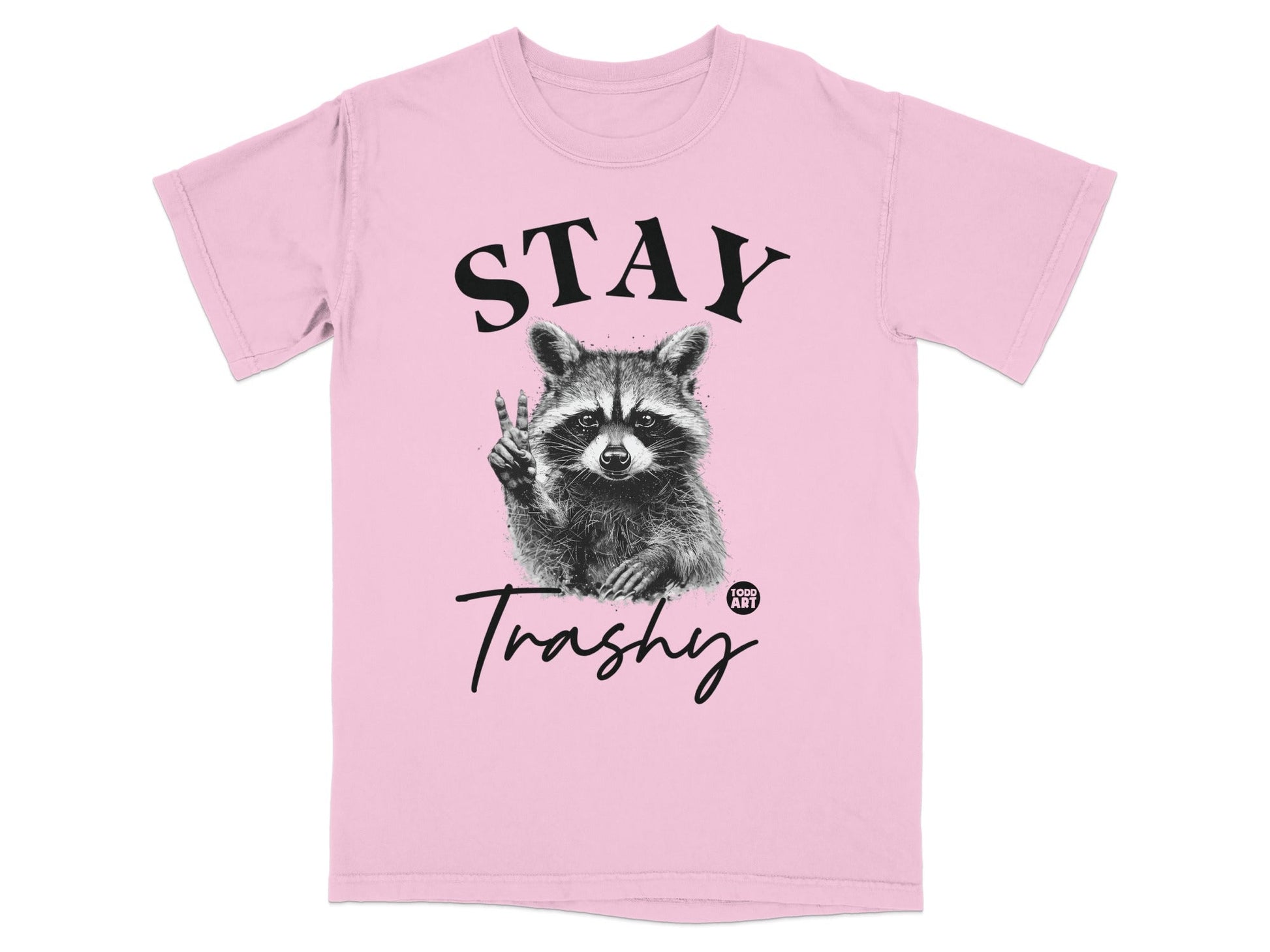 Pink t-shirt with a raccoon giving peace sign and "STAY Trashy" text.