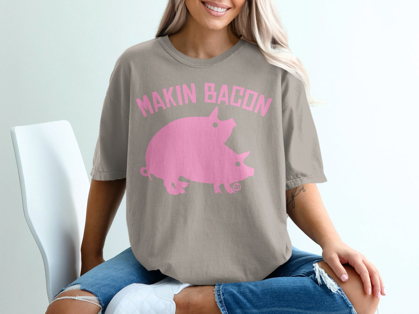 Taupe t-shirt with pink "Makin Bacon" text and two pink pigs.