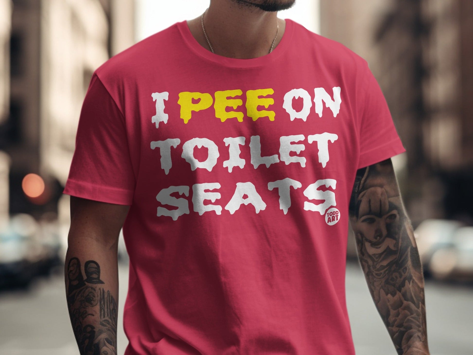 Red t-shirt with yellow and white text reading "I PEE ON TOILET SEATS".