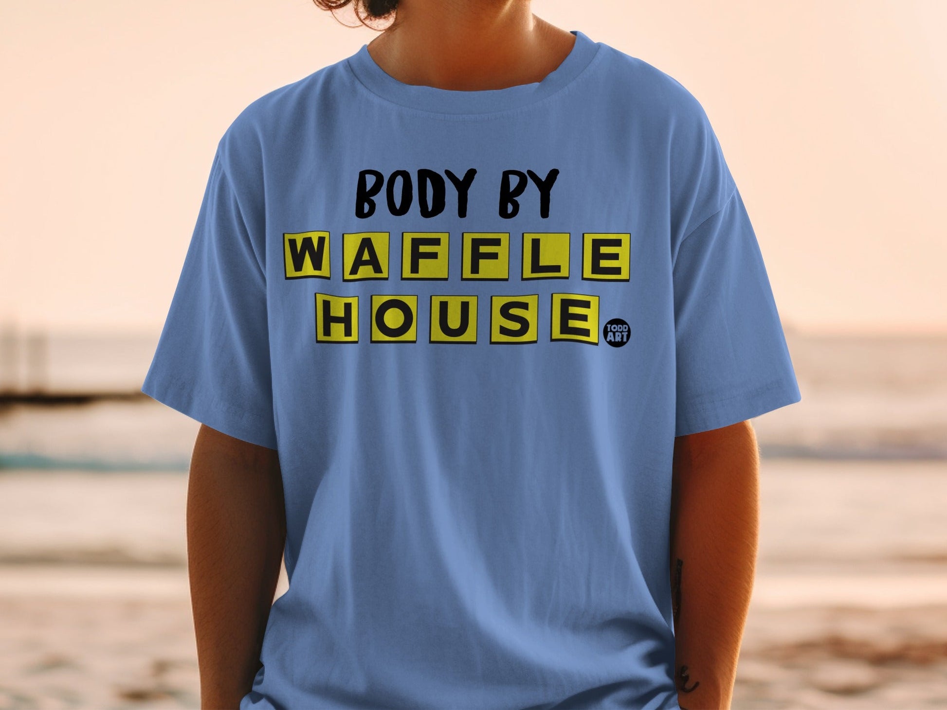 Blue t-shirt with yellow and black "Body By Waffle House" text.