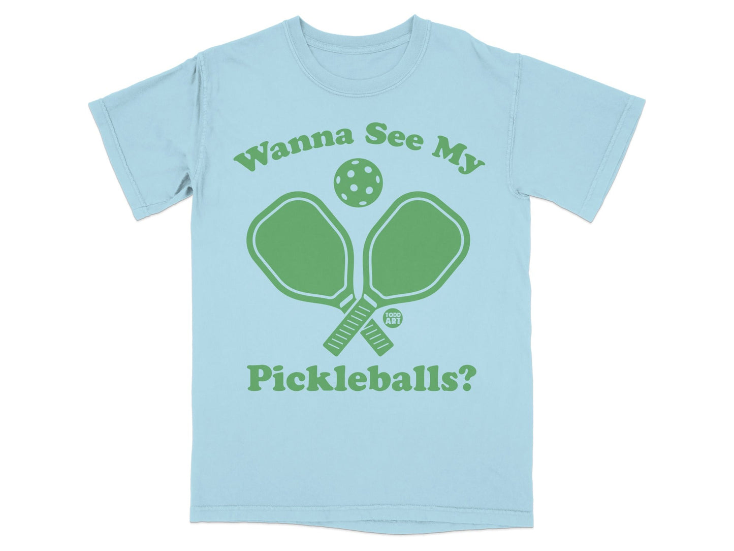 Light blue t-shirt with green pickleball paddles and ball graphic, "Wanna See My Pickleballs?" text.