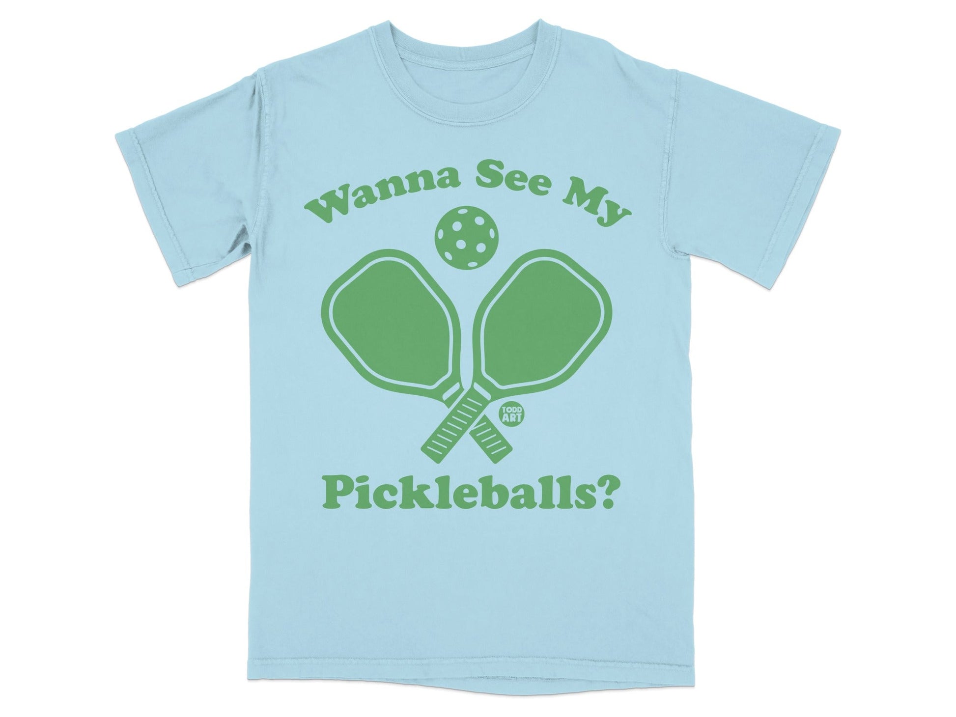 Light blue t-shirt with green pickleball paddles and ball graphic, "Wanna See My Pickleballs?" text.