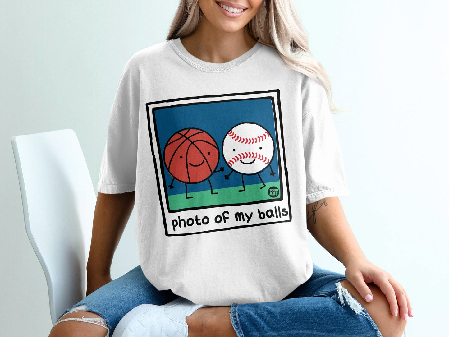 Cartoon basketball and baseball characters holding hands with text "photo of my balls".