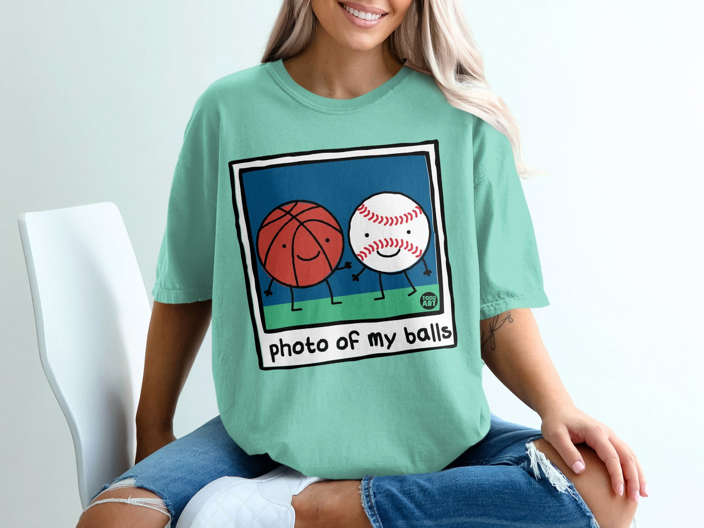 Cartoon basketball and baseball holding hands, with text "photo of my balls".