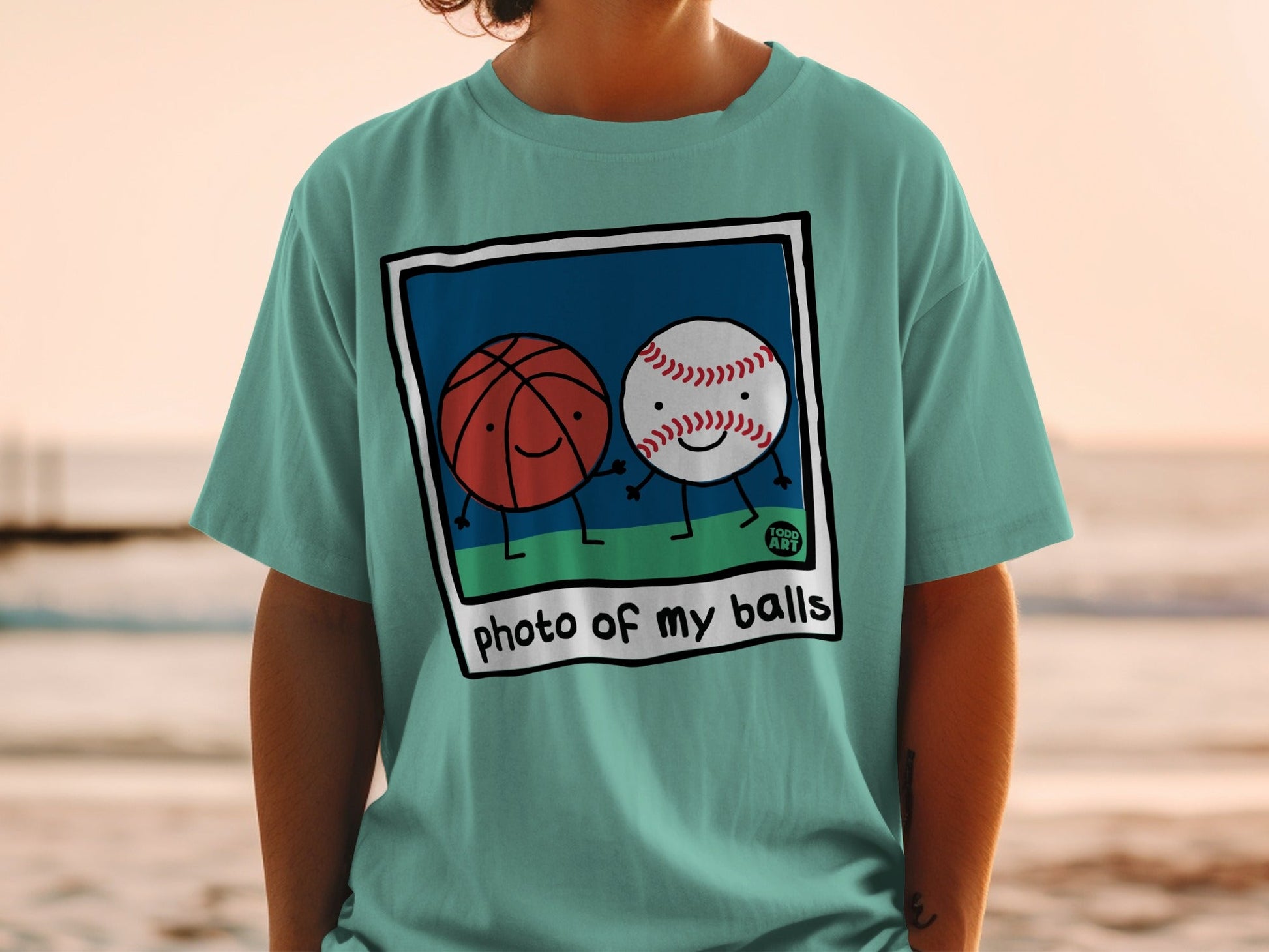 Two cartoon sports balls, a basketball and a baseball, holding hands on a grassy field.