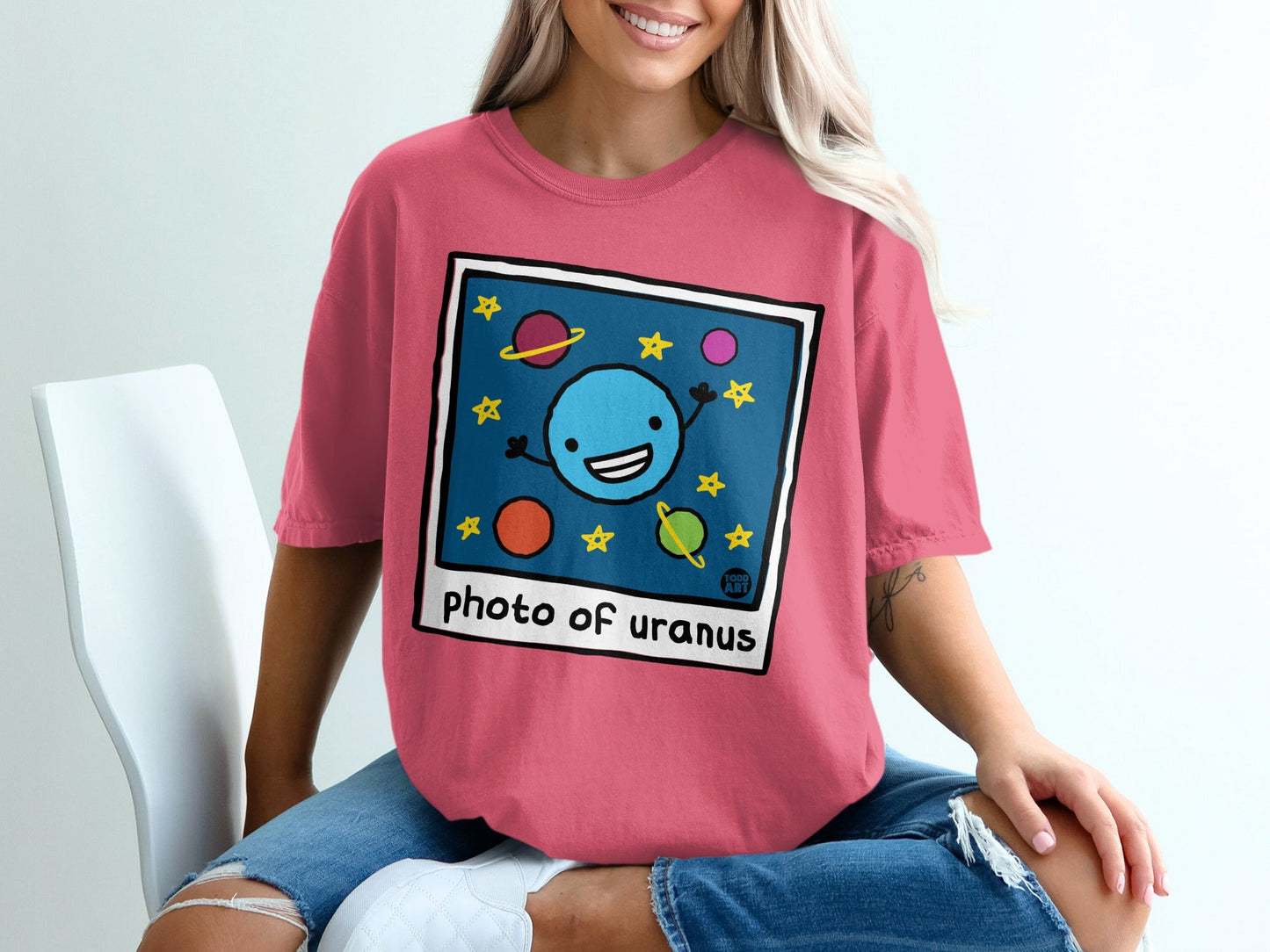 Illustration of a cartoon planet with smiling face, stars, and moons.