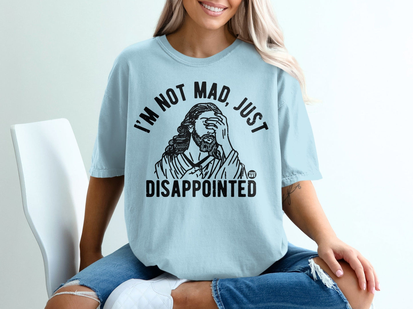 Light blue t-shirt with black text "I'M NOT MAD, JUST DISAPPOINTED".