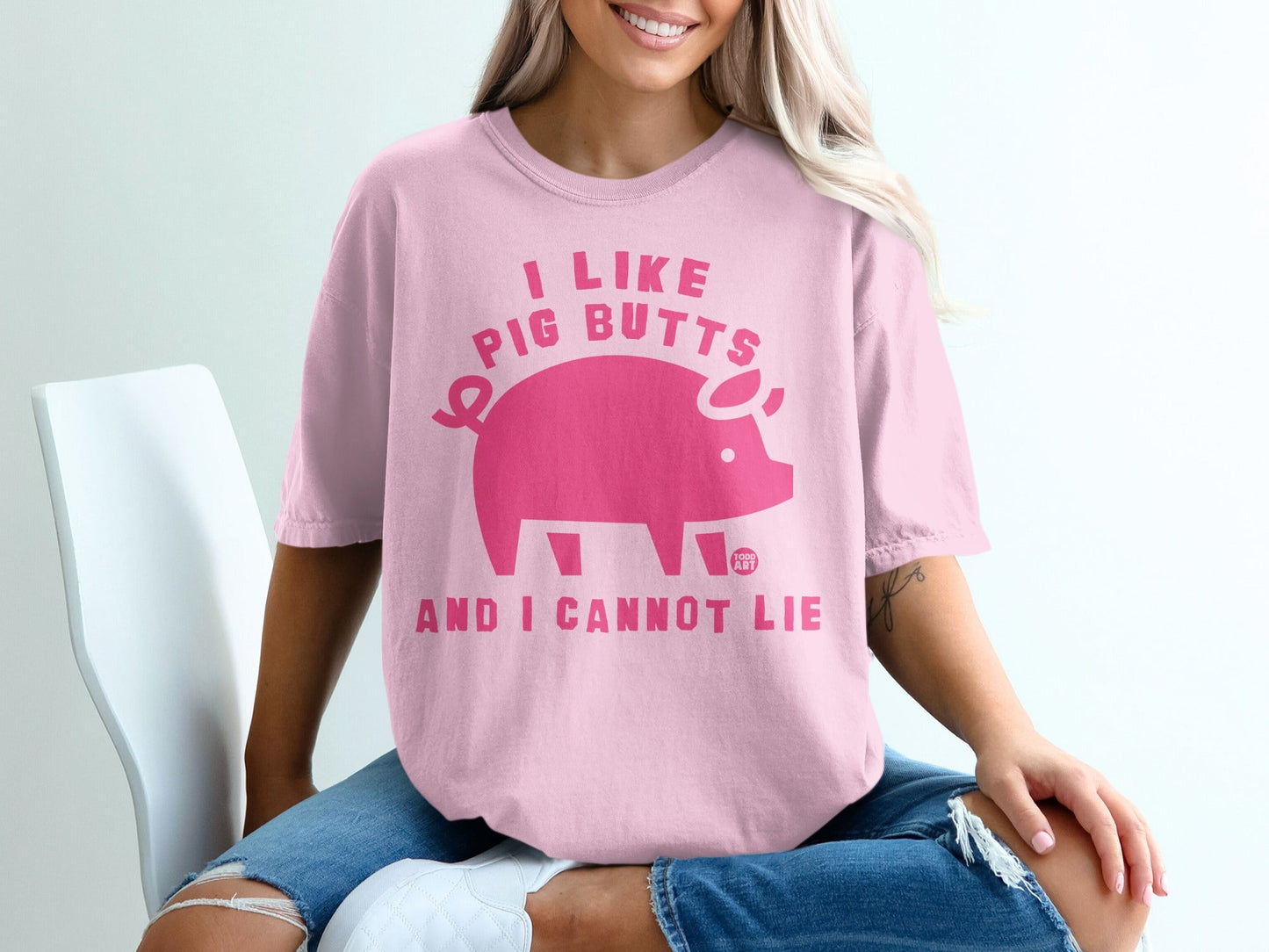 Pink t-shirt with "I like pig butts and I cannot lie" text and a pig graphic.