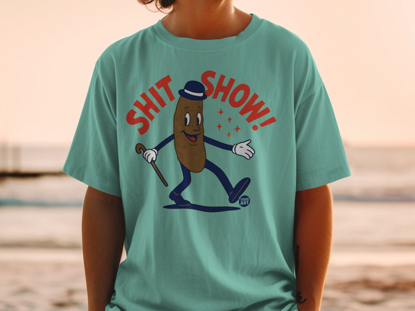 T-shirt with cartoon brown figure wearing a bowler hat and cane, "Shit Show!" text.