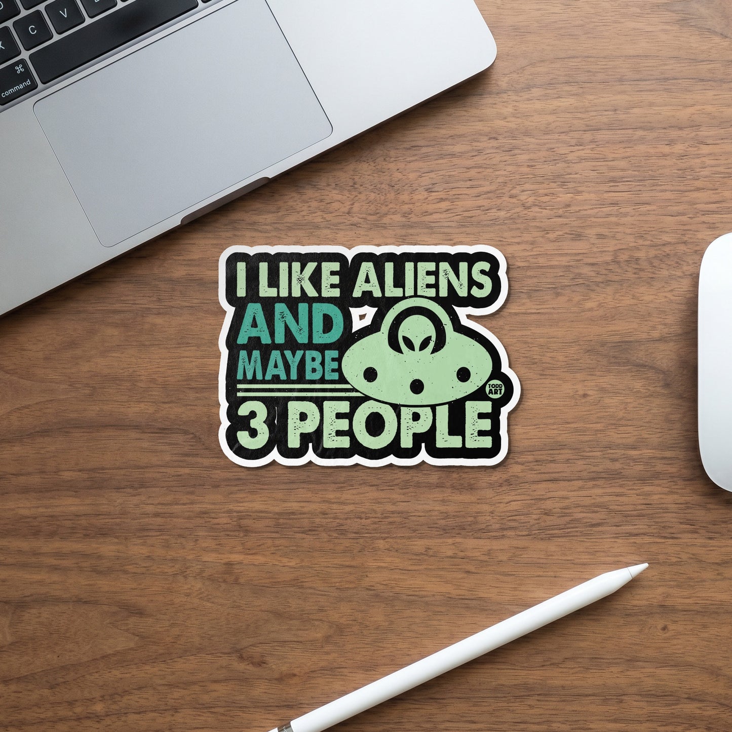Sticker with text "I like aliens and maybe 3 people" and a UFO.