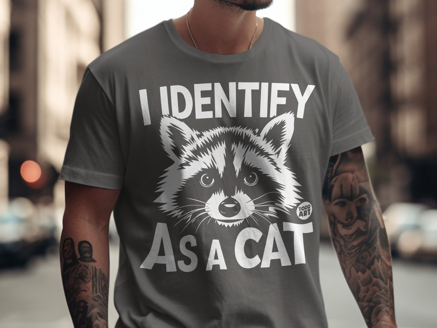 Gray t-shirt with "I IDENTIFY AS A CAT" and raccoon graphic.