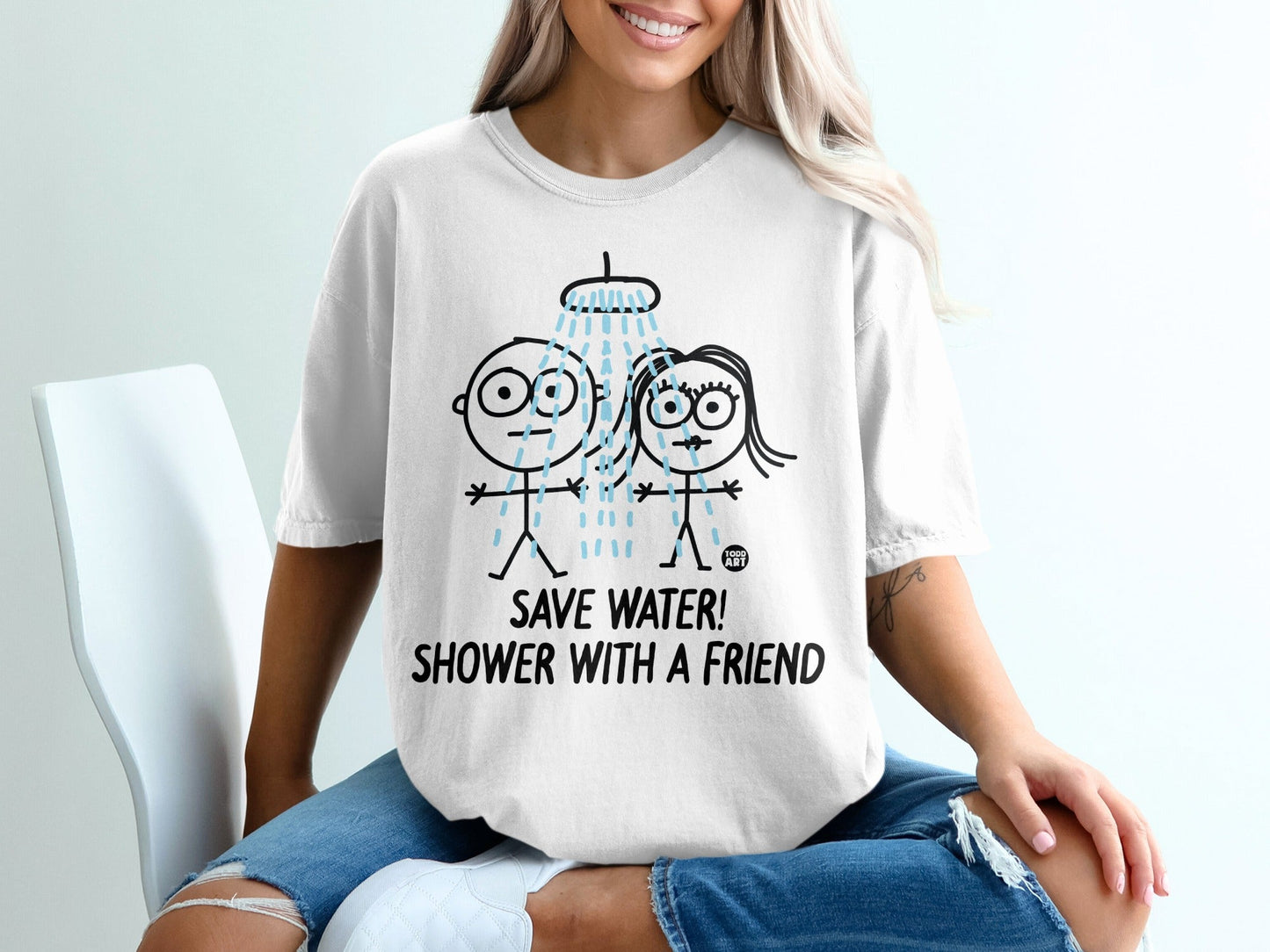 T-shirt with cartoon couple showering together and text "Save Water! Shower With a Friend!".