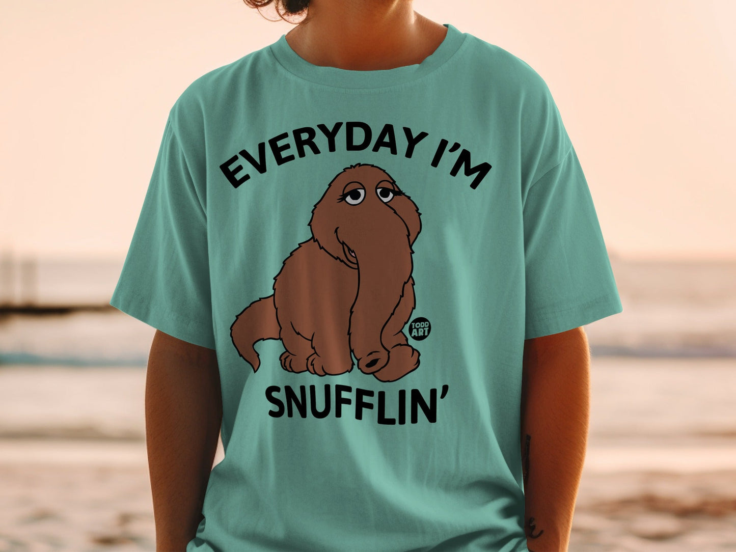 Light blue t-shirt with Snuffleupagus saying "Everyday I'm Snufflin'".