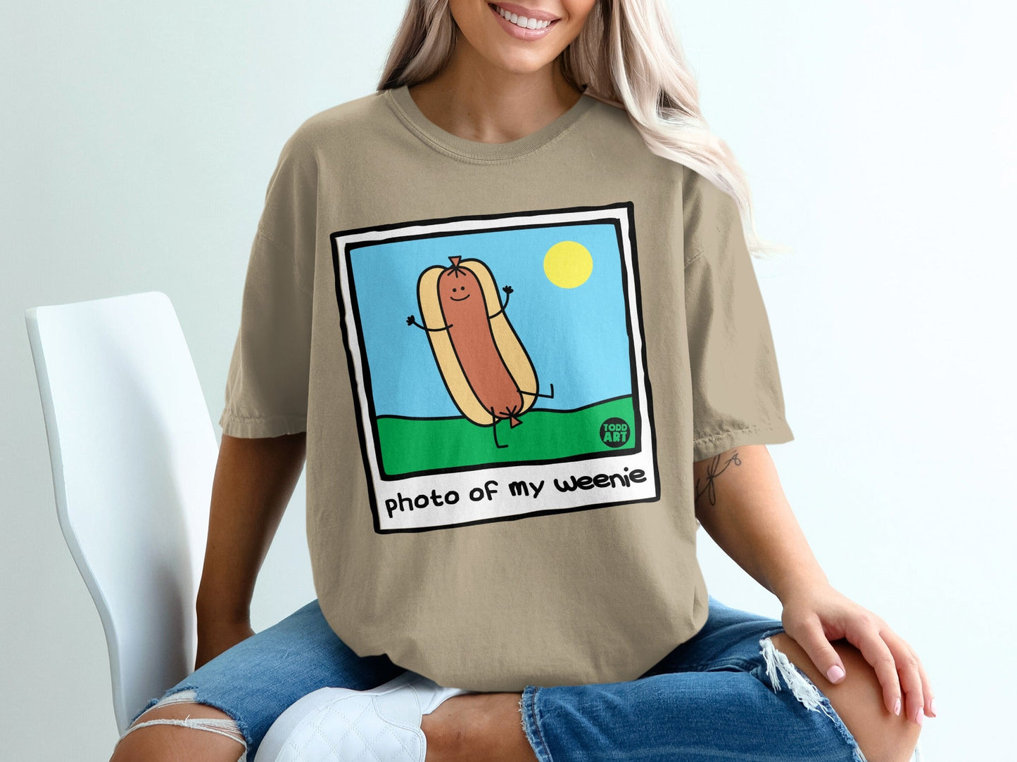 Cartoon hot dog character with arms raised in celebration, text "photo of my weenie".
