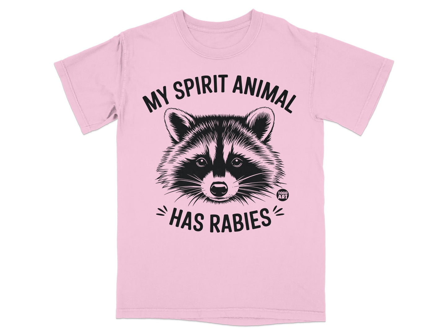 Pink t-shirt with a raccoon illustration and text "MY SPIRIT ANIMAL HAS RABIES".