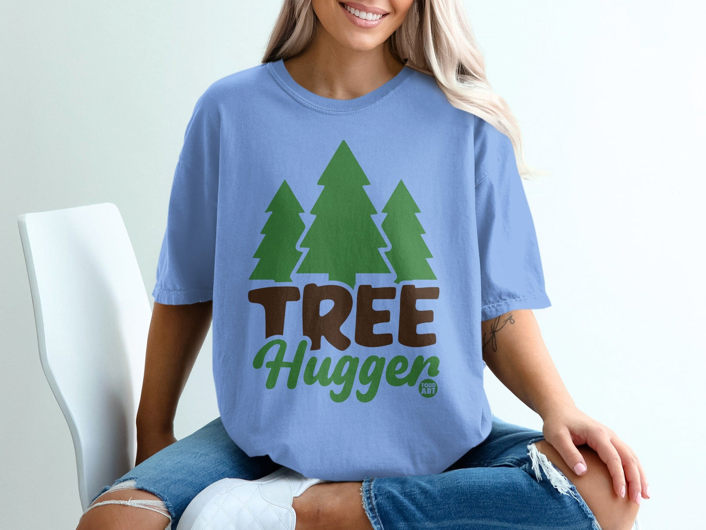 Blue t-shirt with green trees and "TREE Hugger" text.