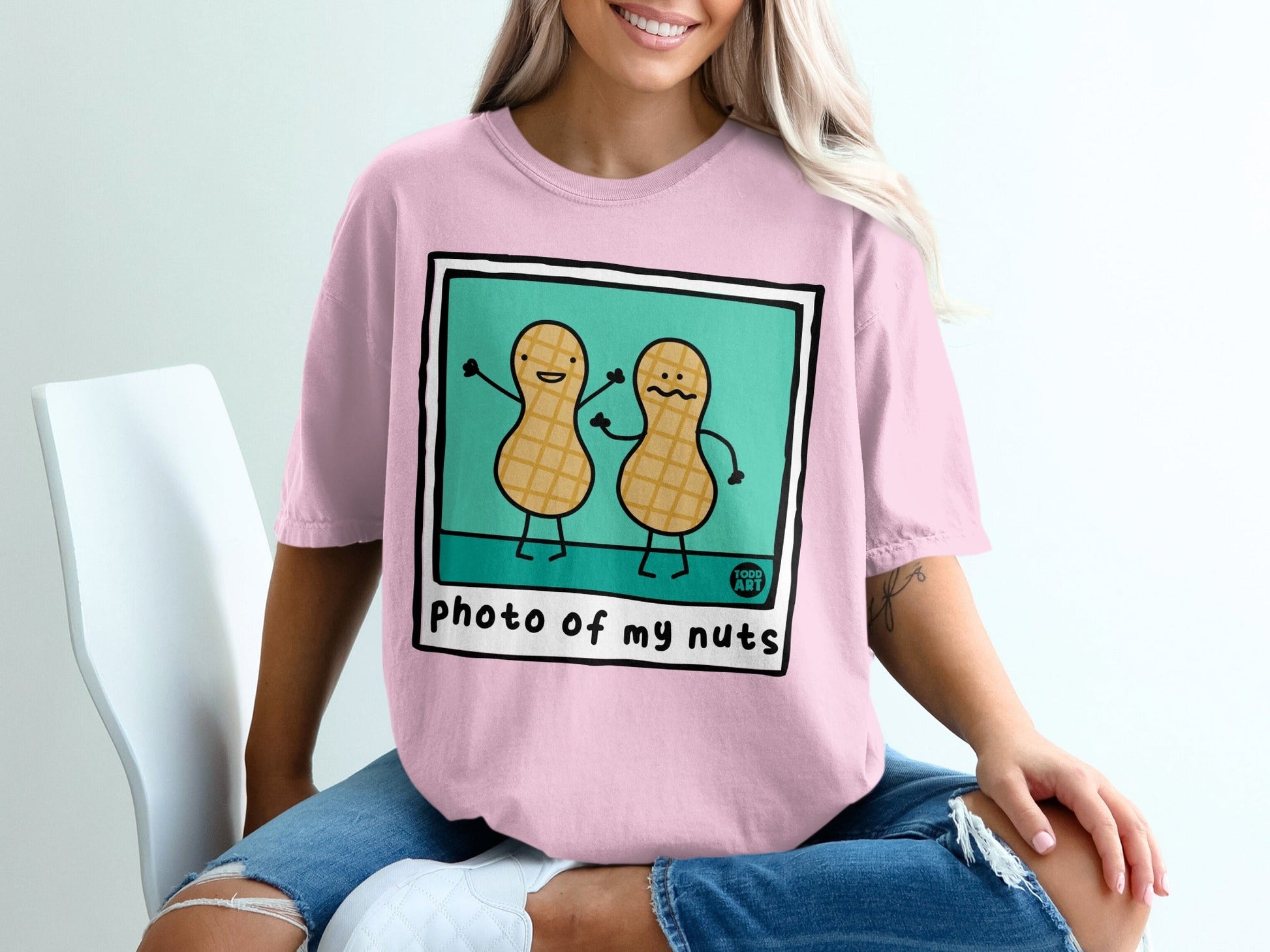 Pink t-shirt with cartoon peanuts saying "photo of my nuts" illustration.