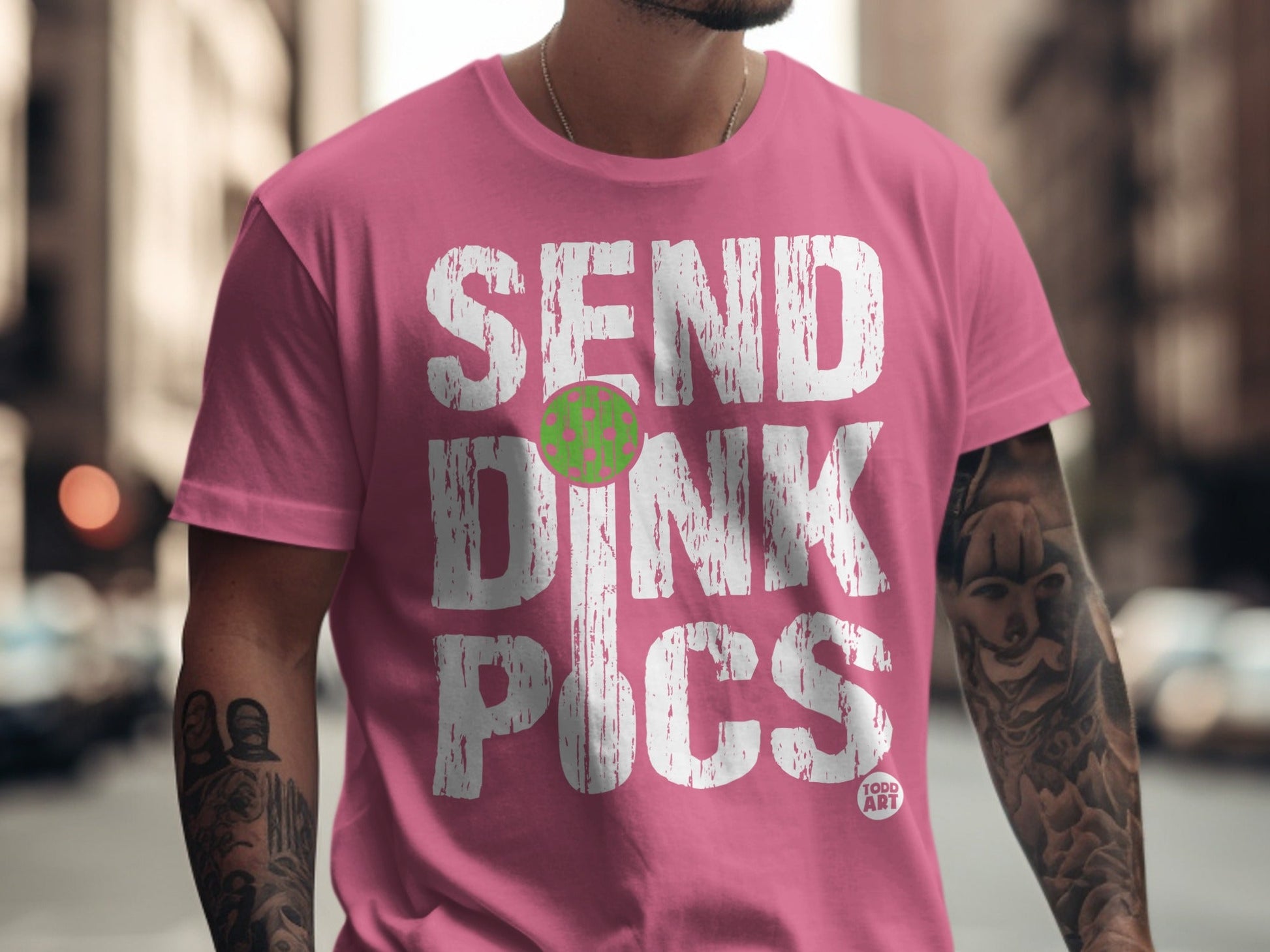 Pink t-shirt with white text "SEND DINK PICS" and a green pickleball.