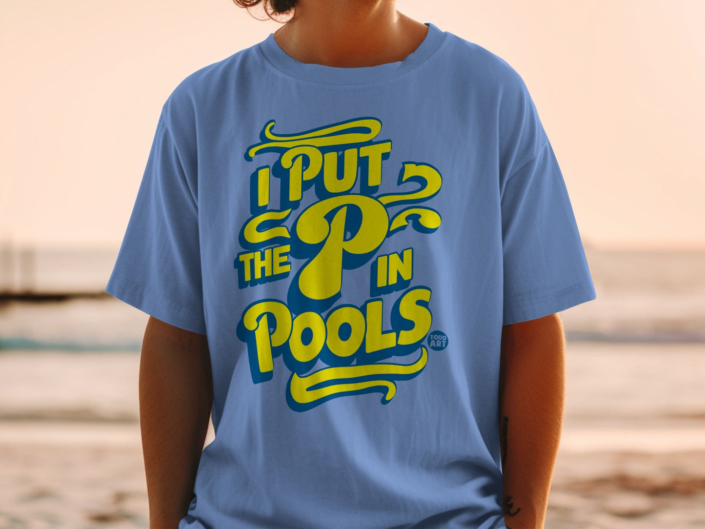 Blue t-shirt with yellow text "I PUT THE P IN POOLS".