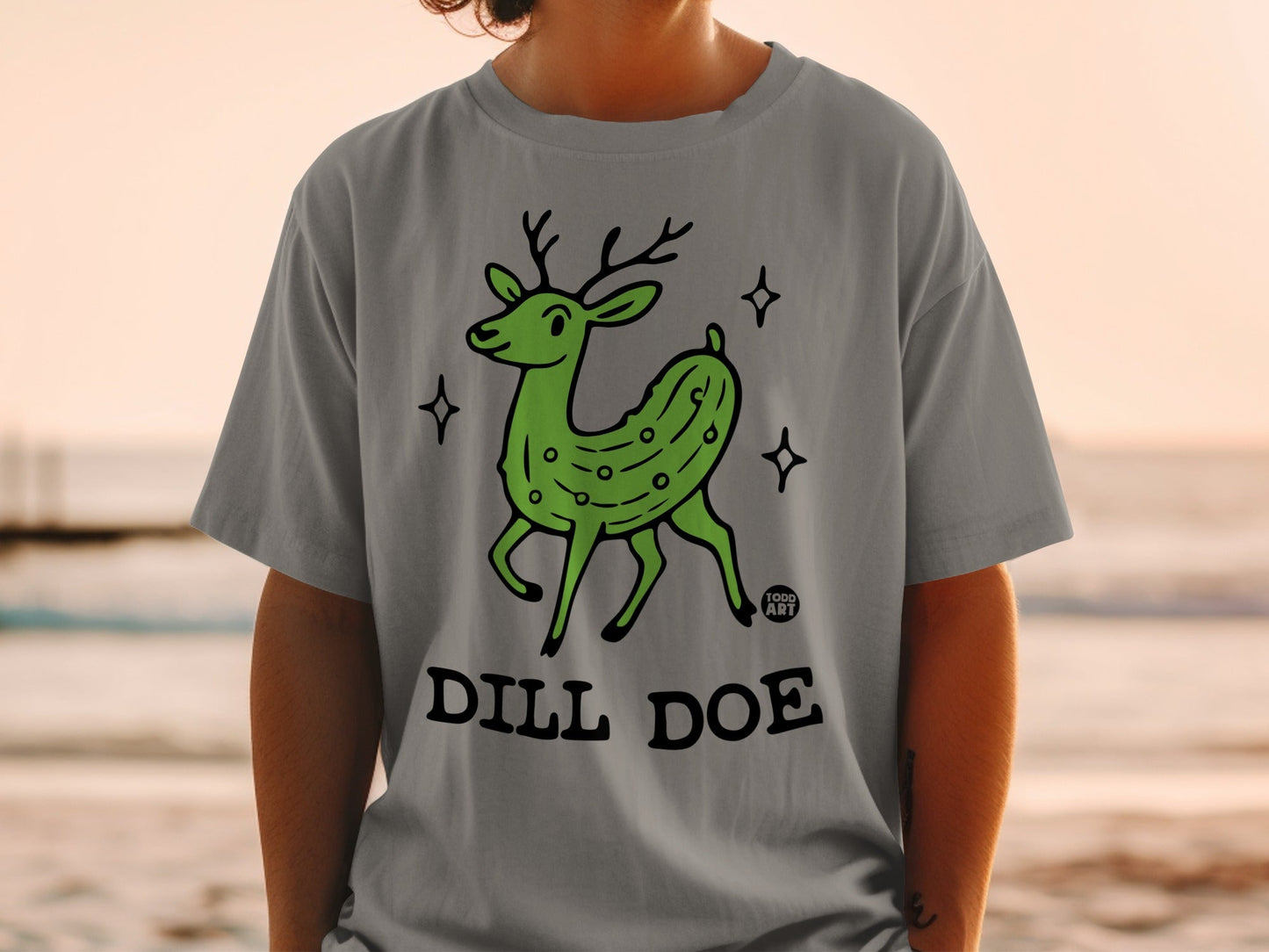 Grey t-shirt with a dill pickle deer illustration and text "DILL DOE".