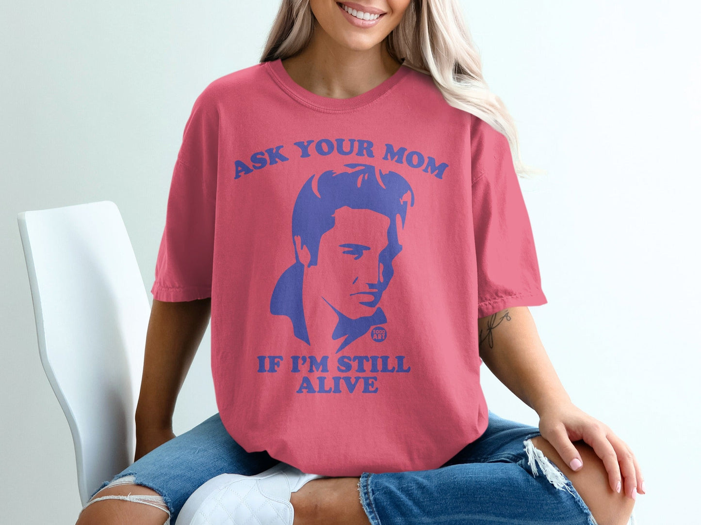 Pink t-shirt with blue graphic of Elvis and text "Ask your mom if I'm still alive".