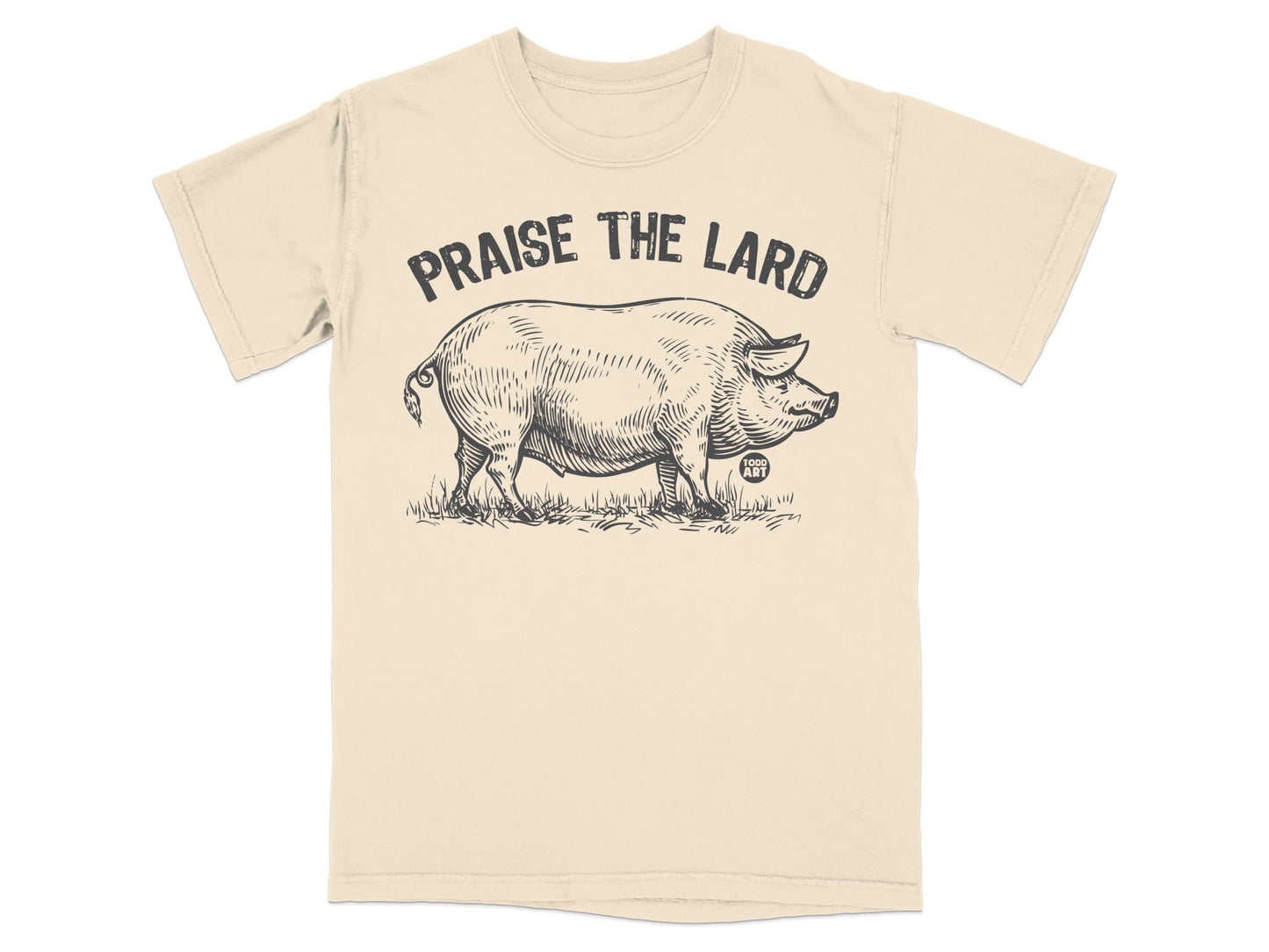 Black and white sketch of a pig on a beige t-shirt with "Praise the Lard" text.