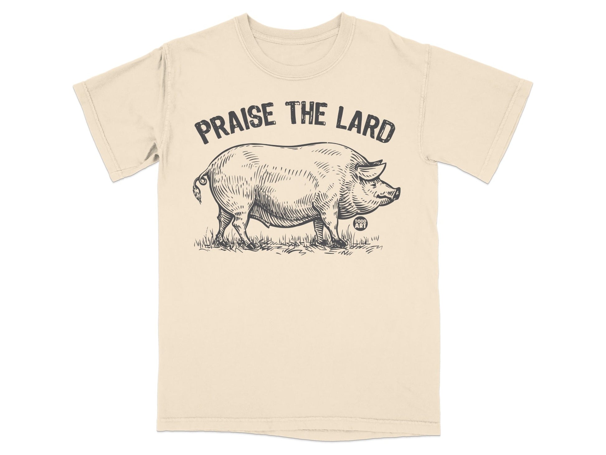 Black and white sketch of a pig on a beige t-shirt with "Praise the Lard" text.