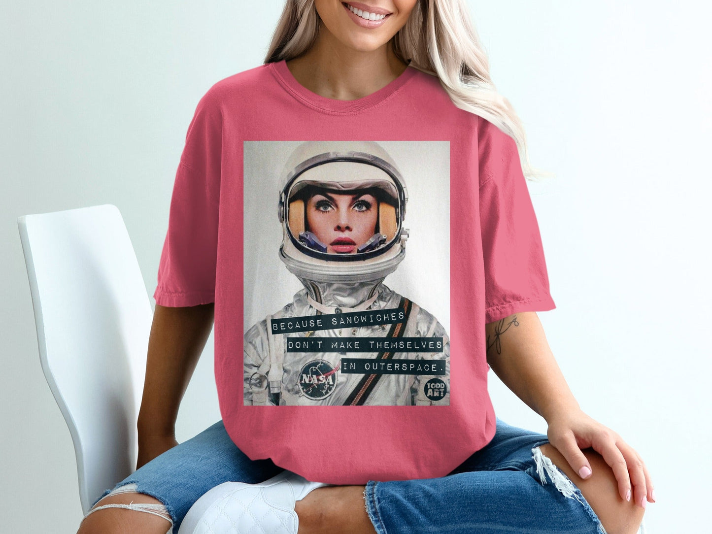 Woman wearing pink t-shirt with NASA astronaut graphic and "Because Sandwiches" text.