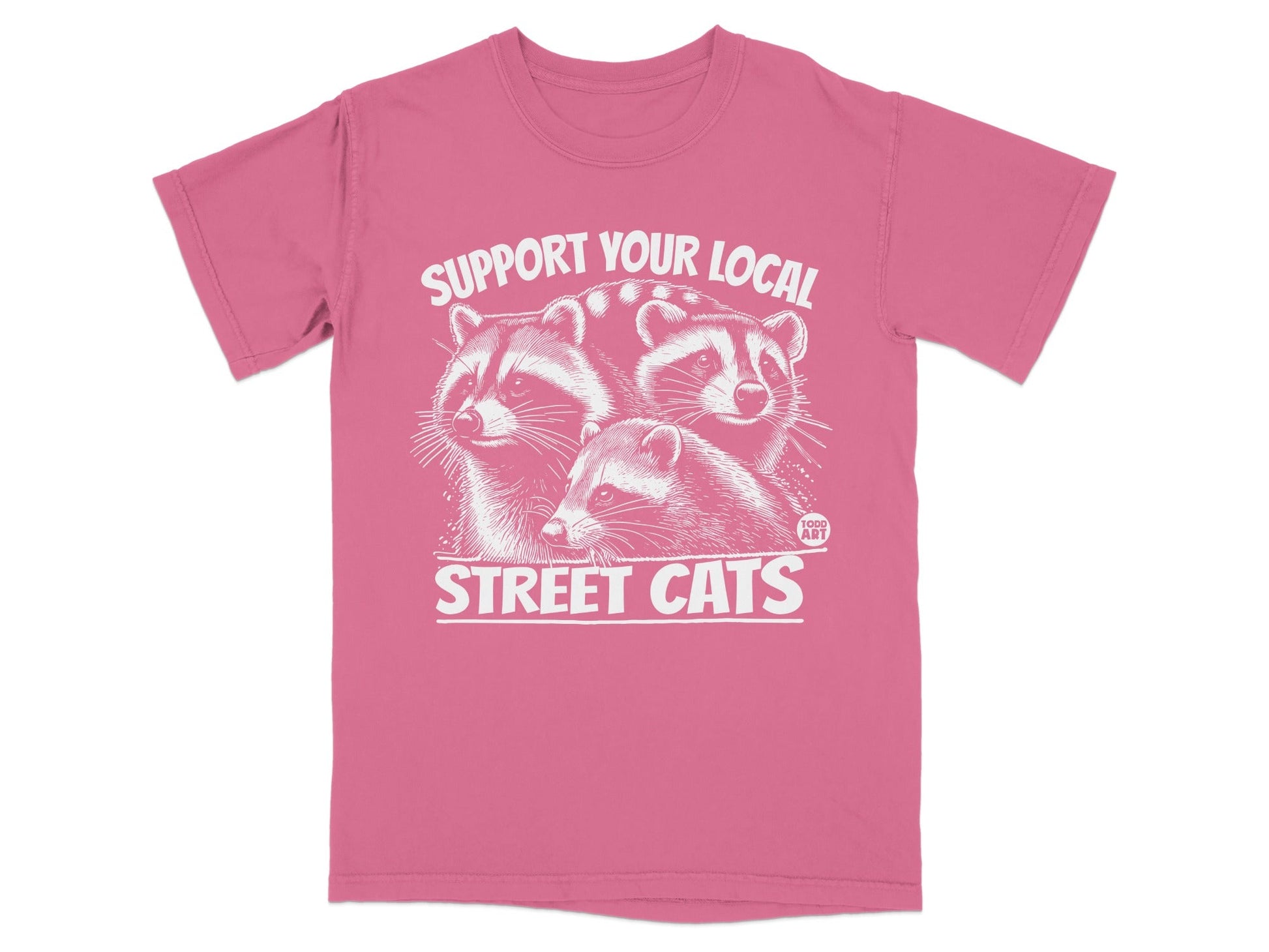 Pink t-shirt with white graphic of three raccoons and text "SUPPORT YOUR LOCAL STREET CATS".