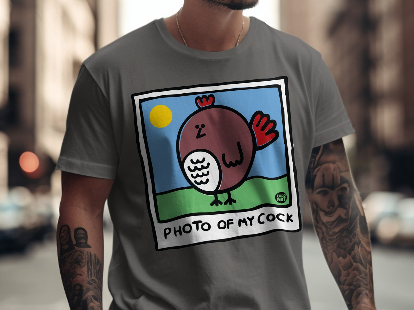 Cartoon chicken in a picture frame on a gray t-shirt.