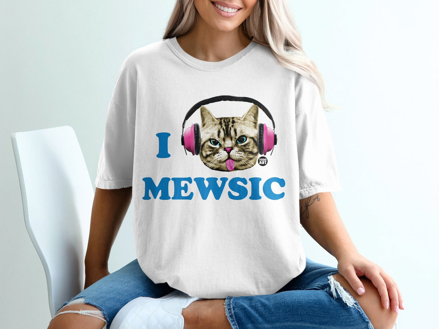 White t-shirt with pink headphones and "I MEWSIC" text.