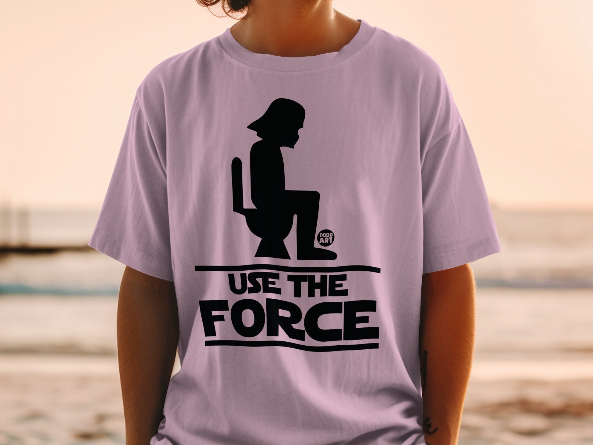 Darth Vader on toilet graphic with "USE THE FORCE" text on a light purple t-shirt.