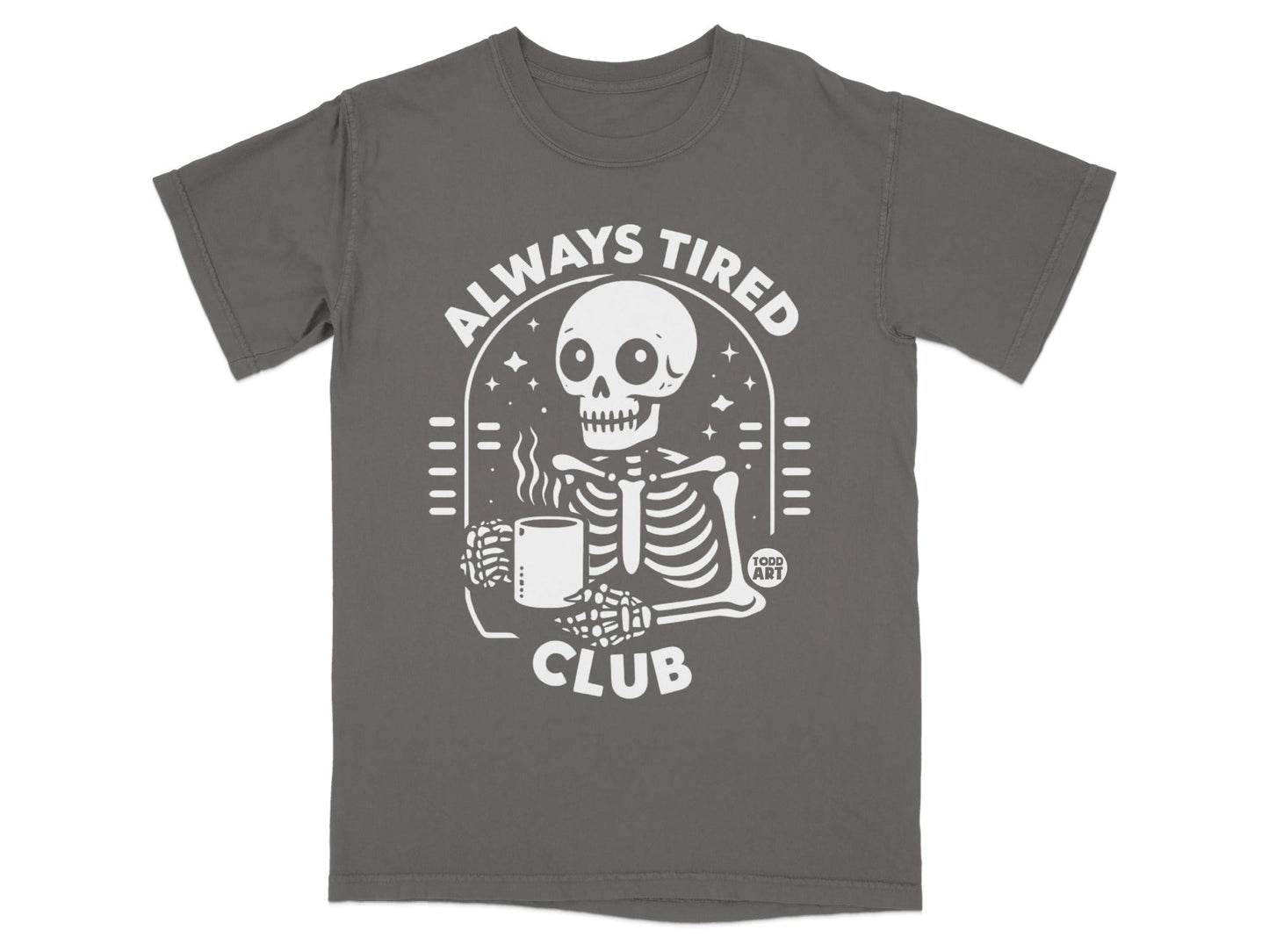 Gray t-shirt featuring a skeleton holding a coffee mug with "ALWAYS TIRED CLUB" text.