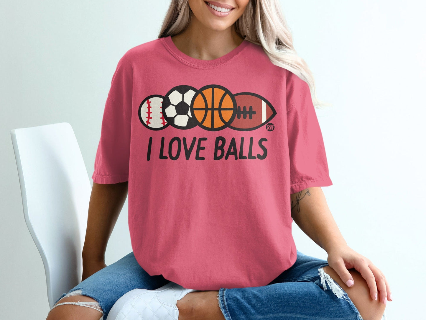 Pink t-shirt with "I LOVE BALLS" and images of various sports balls.