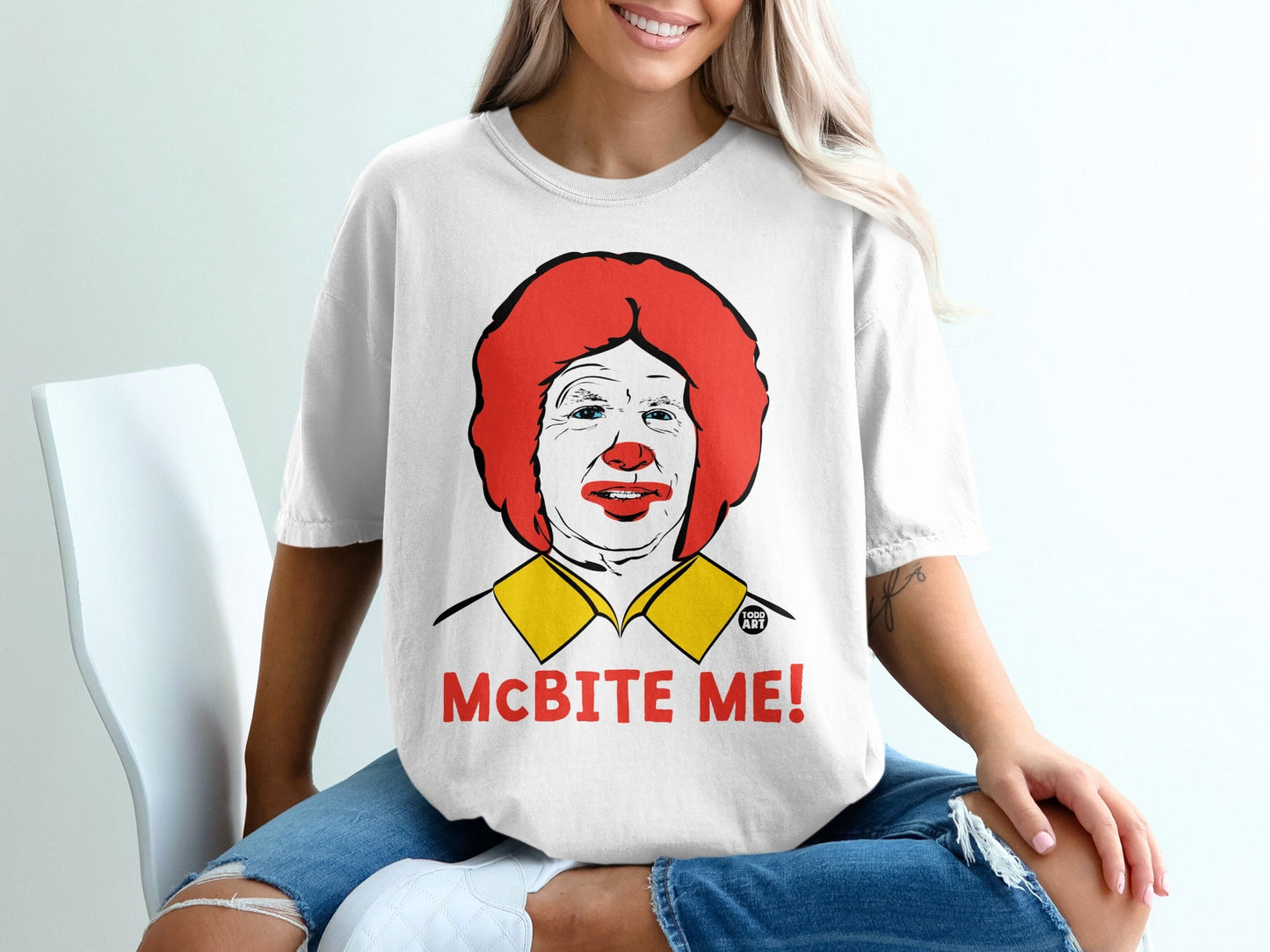White t-shirt with Ronald McDonald's face and "McBITE ME!" text.