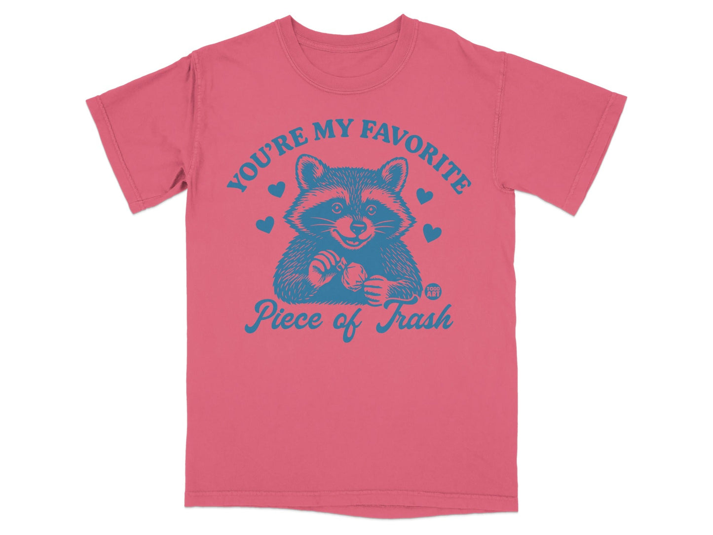 Pink t-shirt with raccoon graphic and text "You're my favorite piece of trash".
