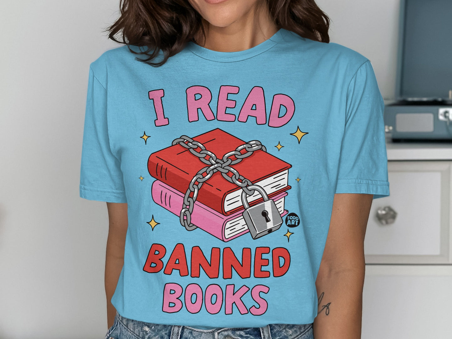 Light blue t-shirt with "I READ BANNED BOOKS" text and chained, locked books graphic.