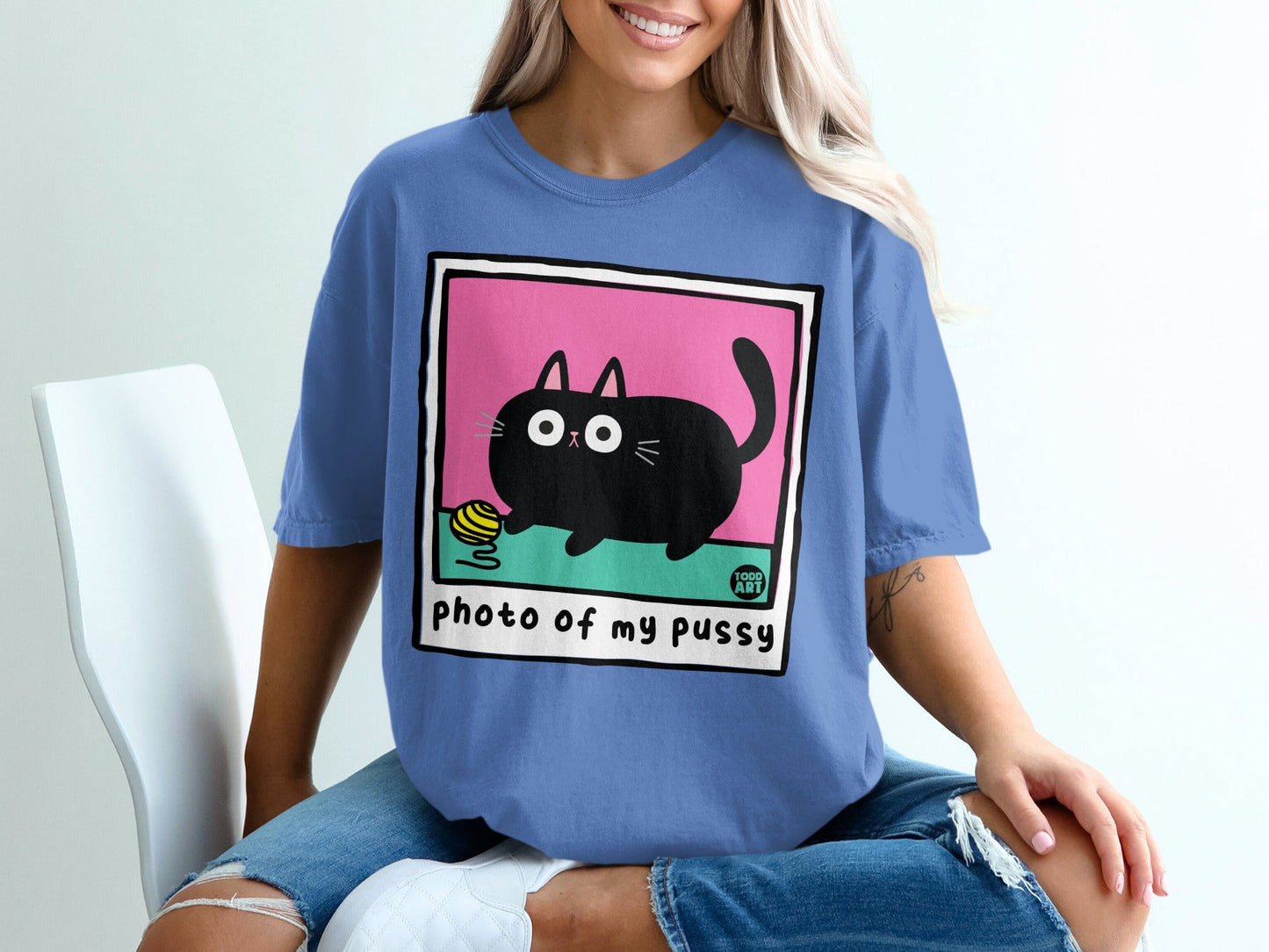 Black cat with yarn on pink background, "photo of my pussy" text.