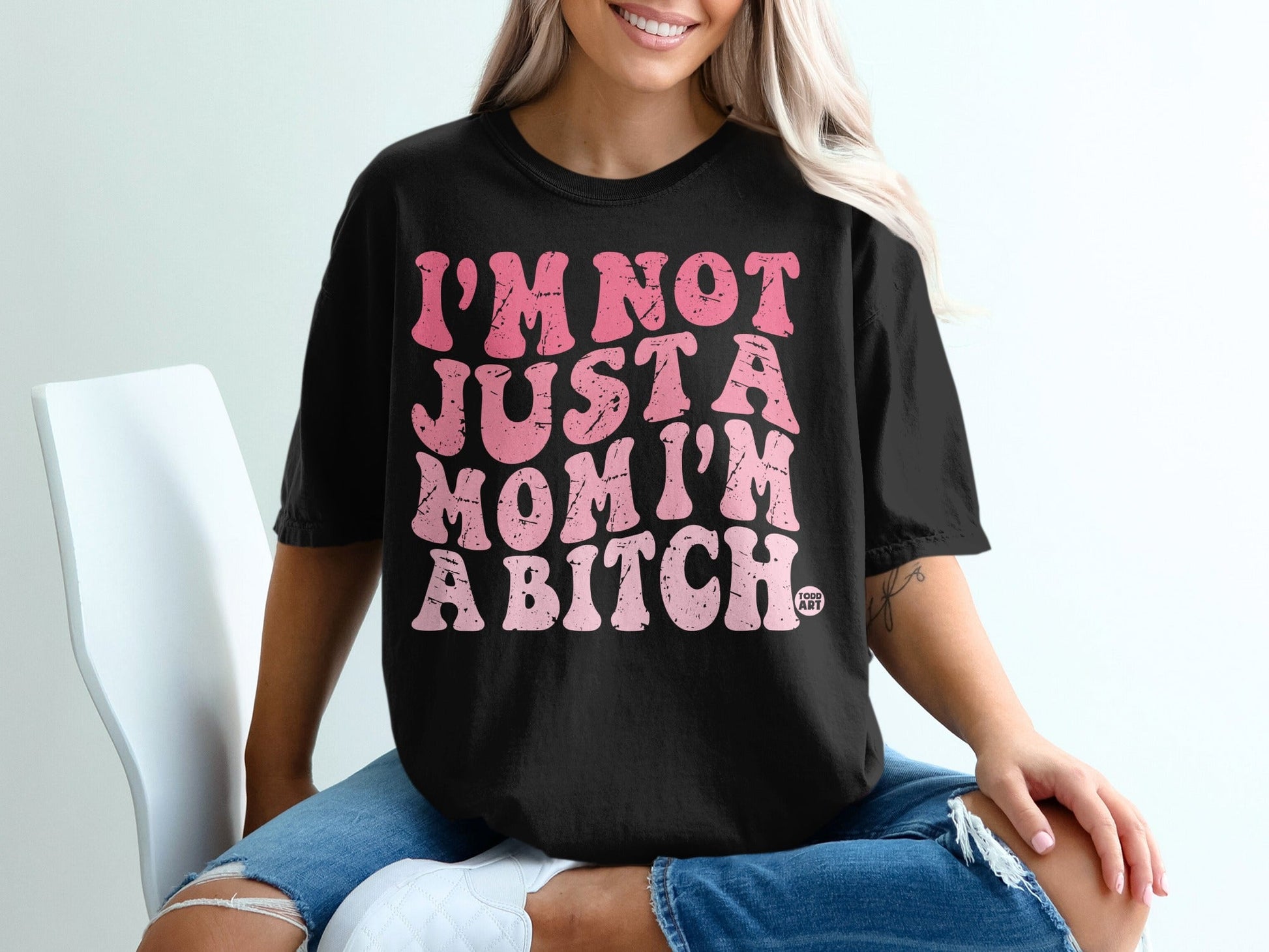 Black t-shirt with pink text reading "I'M NOT JUST A MOM I'M A BITCH."