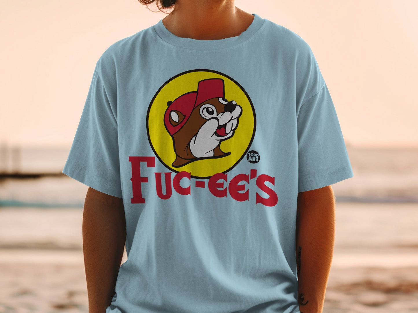 Light blue t-shirt with Bucee's logo featuring a beaver wearing a red hat.