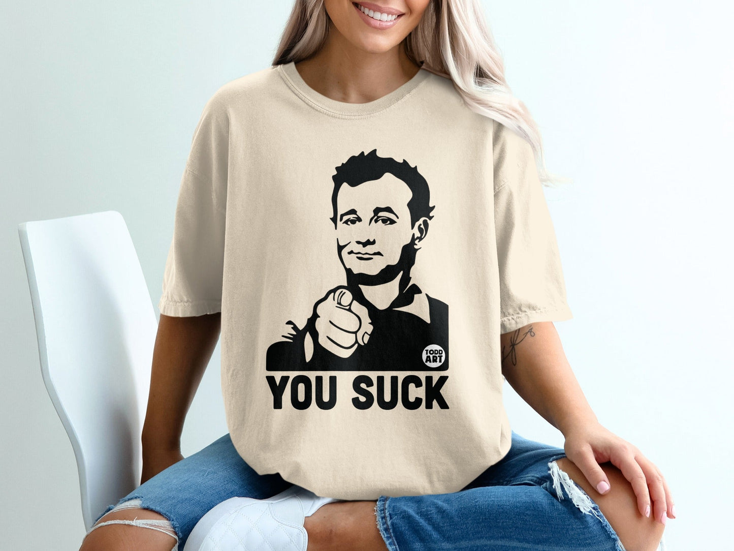 T-shirt with a graphic of a man pointing and the text "YOU SUCK".