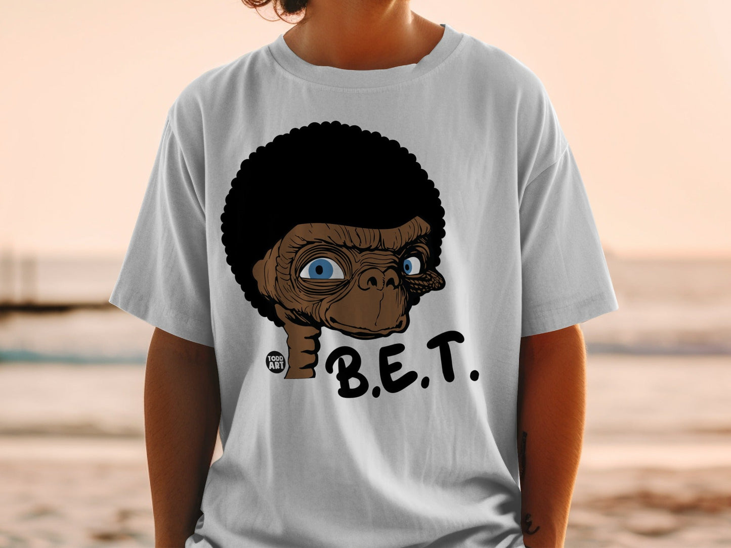 White t-shirt with ET character graphic and "B.E.T." text.