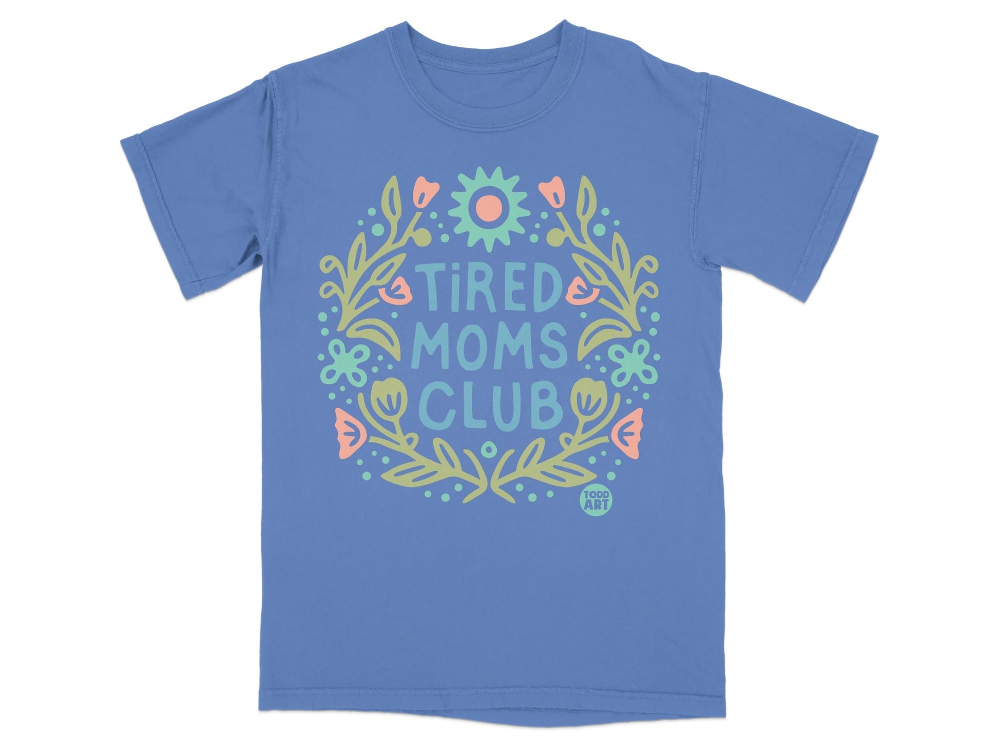 Blue t-shirt with "Tired Moms Club" text and floral wreath.