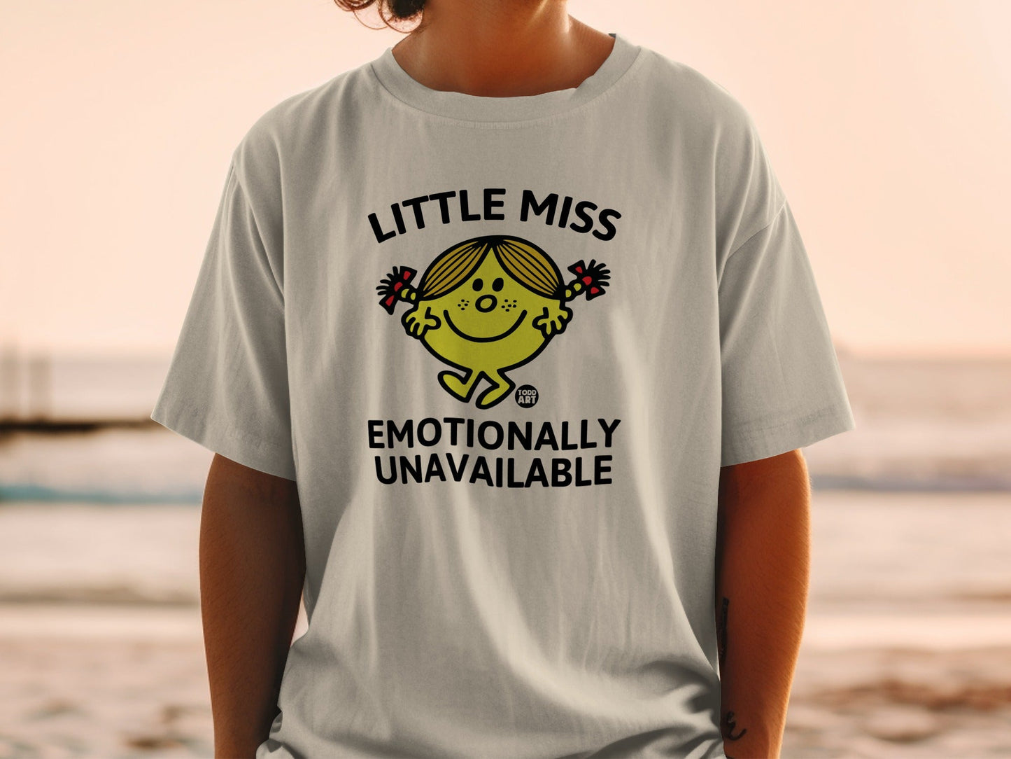 Little Miss Emotionally Unavailable graphic tee on a light grey t-shirt.