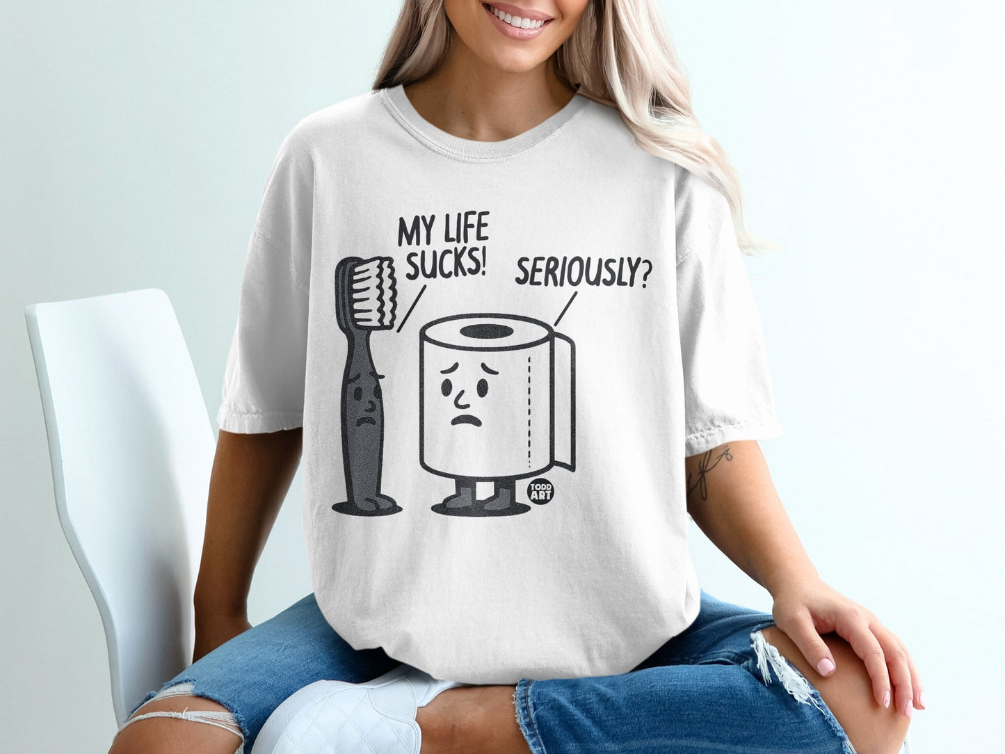 T-shirt graphic with sad toothbrush and toilet paper: "MY LIFE SUCKS! SERIOUSLY?"